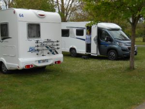 Two motorhomes parked in a campsite in France