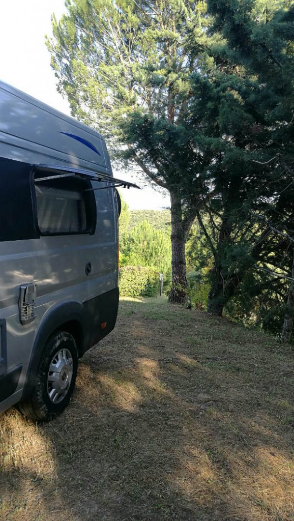 Shaded motorhome pitch at Domaine d'Arnauteille campsite