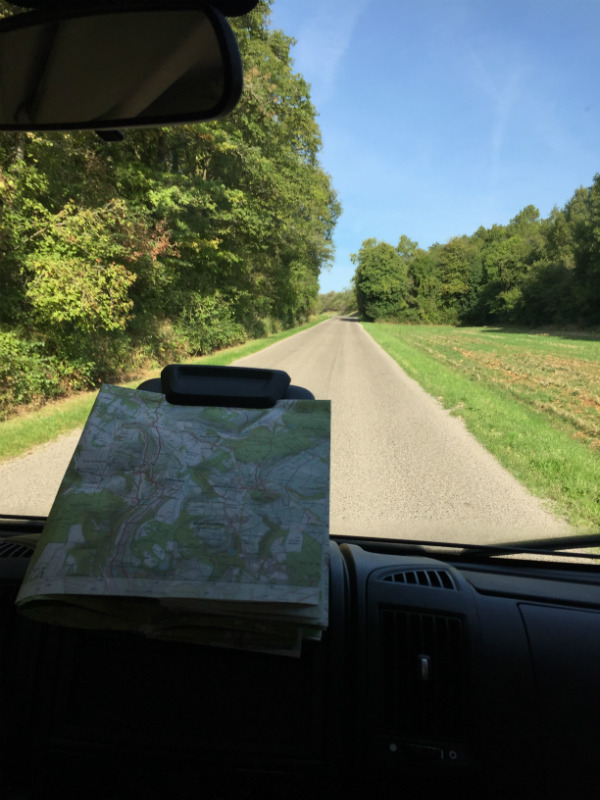 A map clipped to a board on the dashboard of a campervan