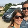 Couple in front of a motorhome and French chateau