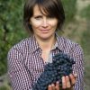 Woman holding huge bunch of black grapes